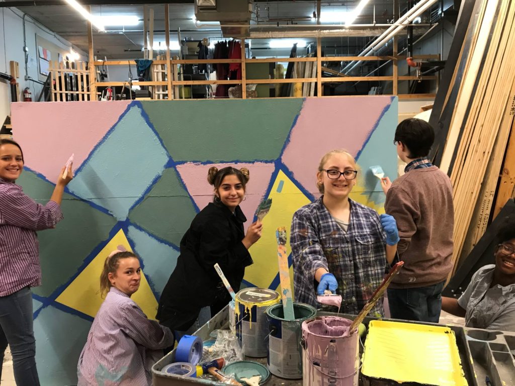 Students paint a set piece